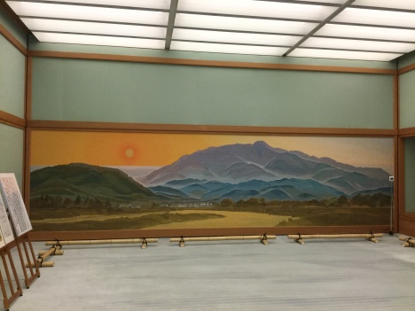Woven fabric tapestry with the setting sun behind the mountains in Arashiyama, area famous for bamboo forest